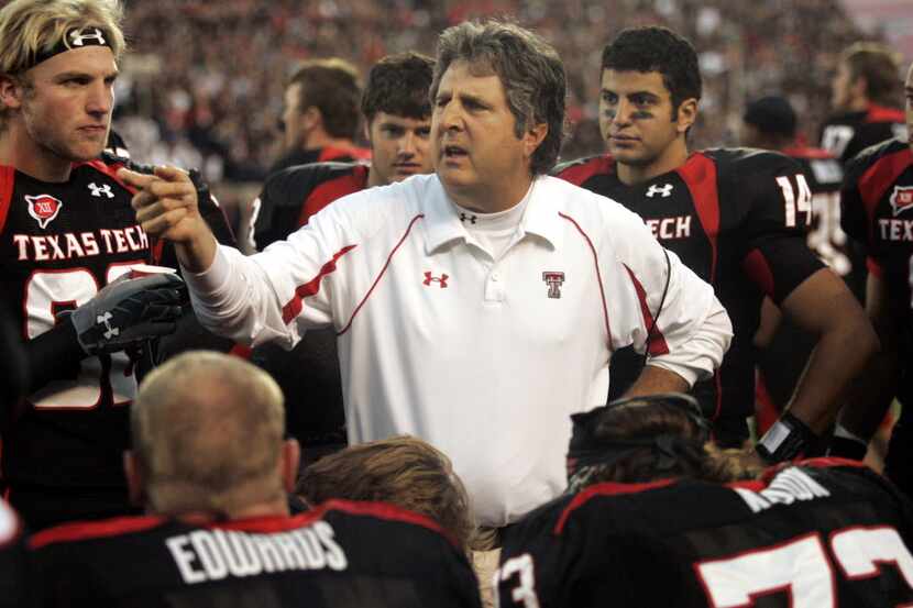 FILE - In this Oct. 24, 2009, file photo, Texas Tech coach Mike Leach talks with his team...