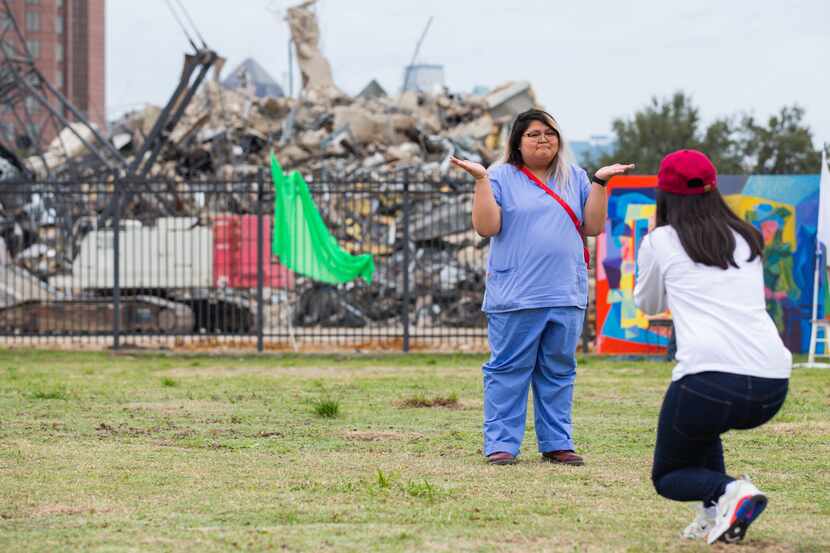 Jamila Alvarez takes a photo of Sarah Cruz in front of the remains of the Affiliated...