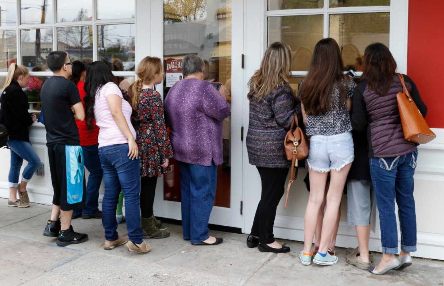 Fans peer inside of Carlo's Bakery trying to get a glimpse of Cake Boss, Buddy Valastro on...