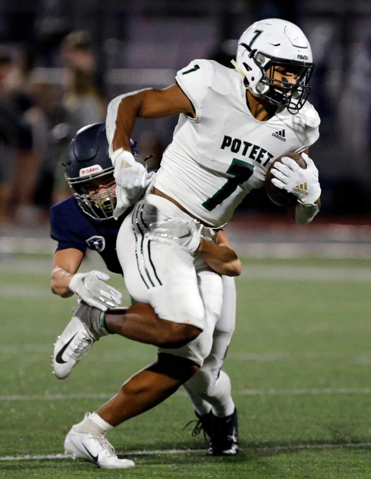 Mesquite Poteet's Seth McGowan (7) picks up a a couple of yards during the first half of...