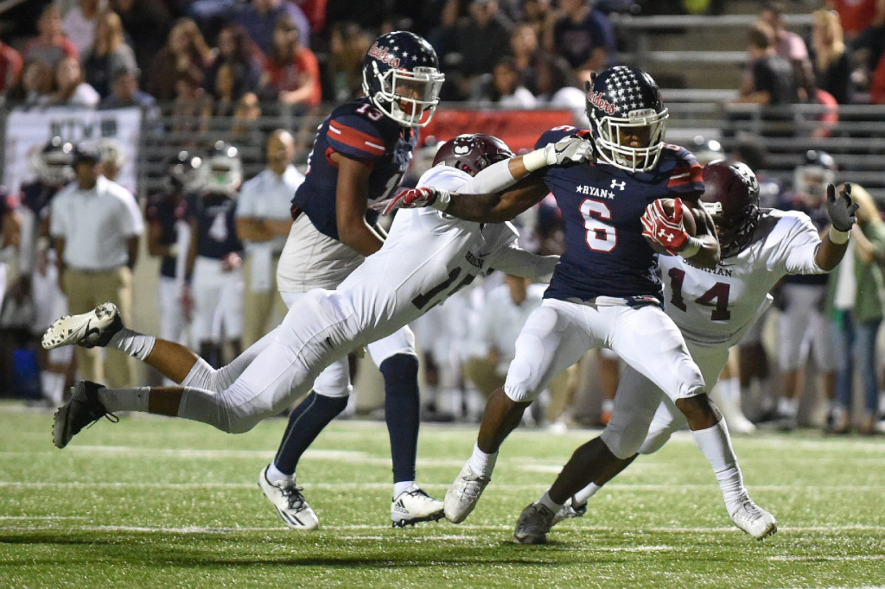 Ryan junior running back Tamar Butts (6) runs the ball while Sherman junior linebacker...