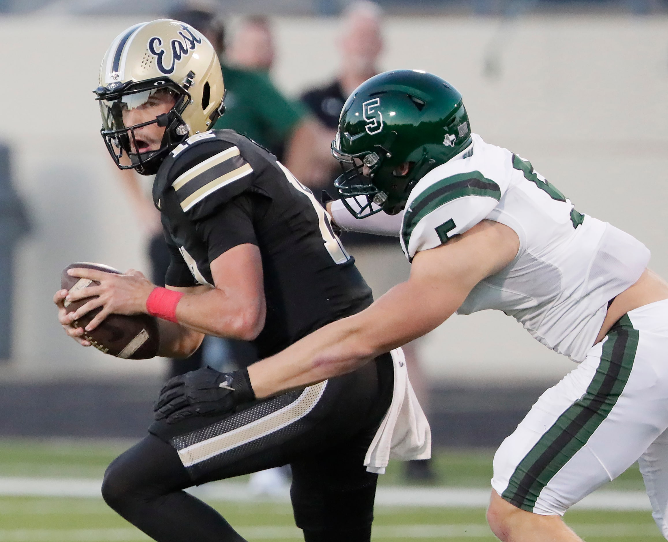 Plano East High School quarterback Jackson Hays (12) is sacked by Prosper High School...