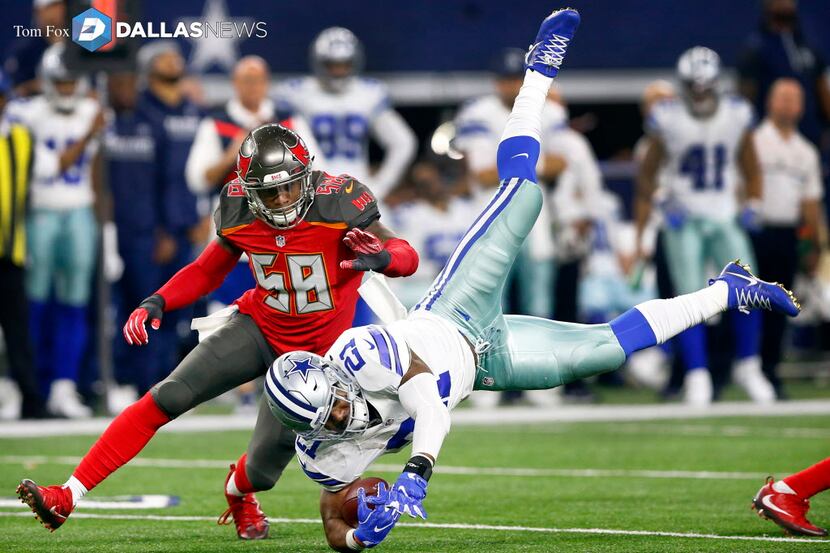 Dallas Cowboys running back Ezekiel Elliott (21) flies through the air as he hurdled Tampa...