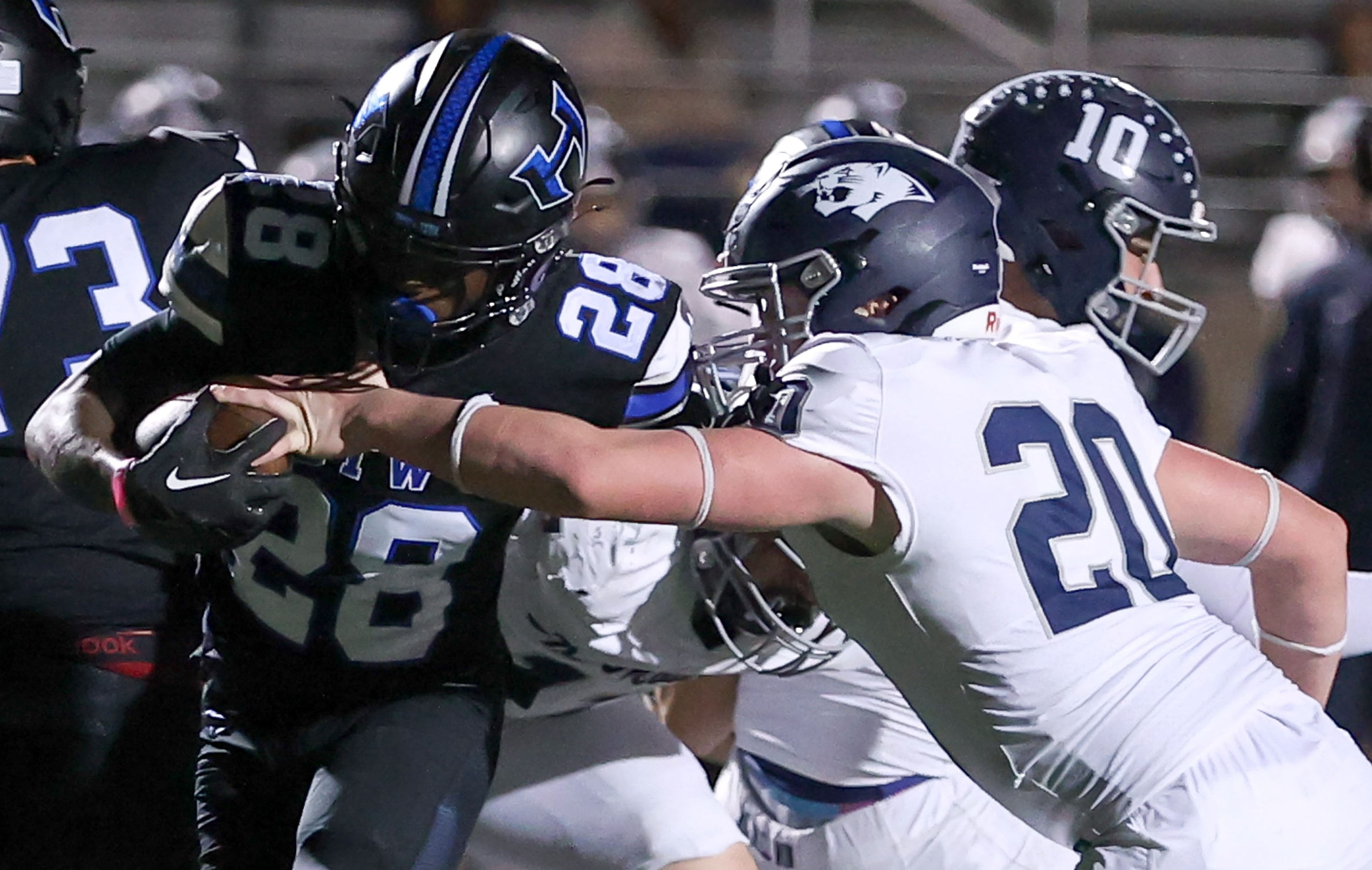 Hebron running back Marcus Nathaniel-Johnson (28) tries to get past Flower Mound linebacker...