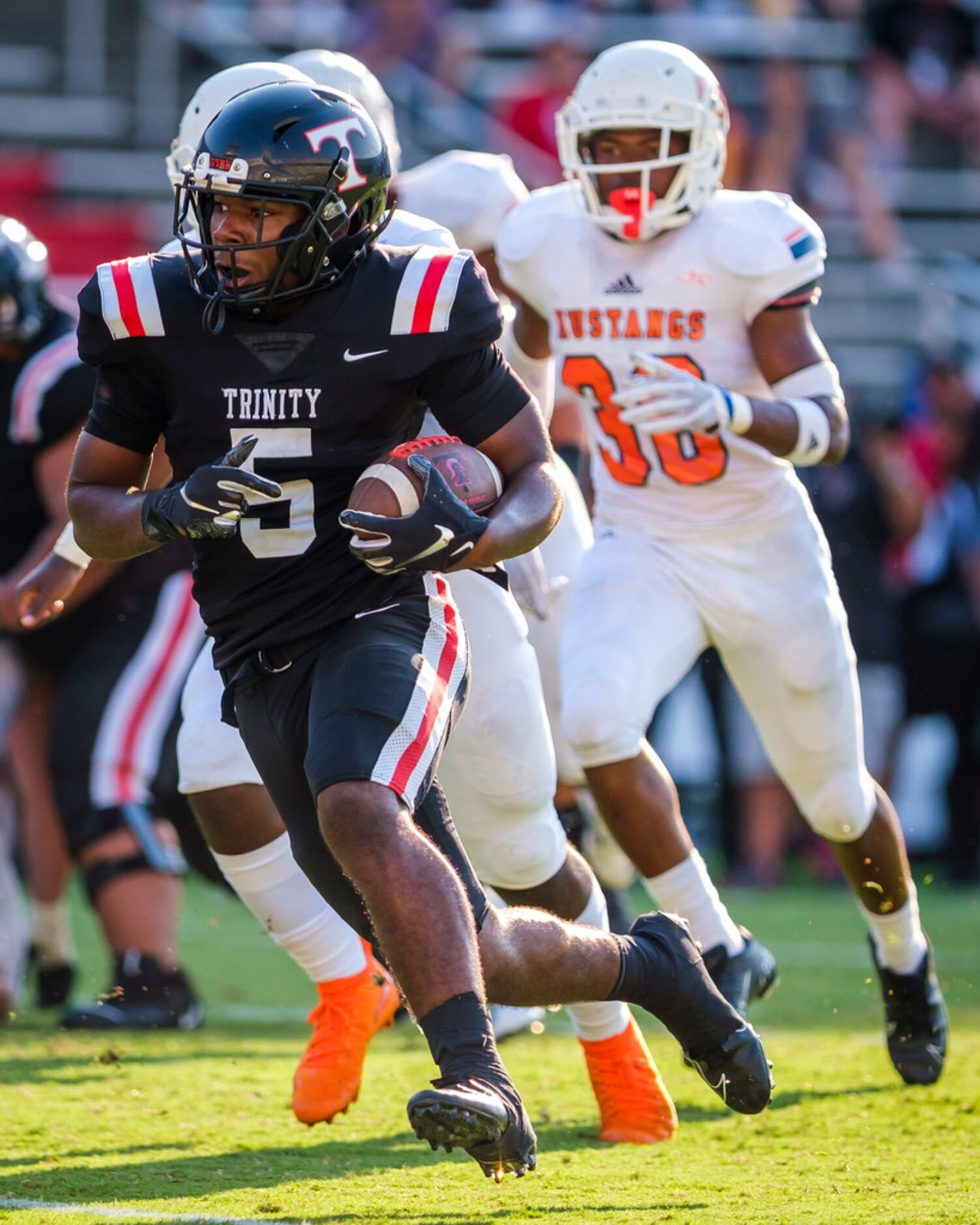 Euless Trinity running back AJ Barnett (5) breaks through the Sachse defense on his way to a...