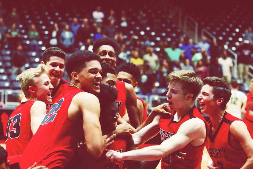 The Frisco Liberty boys basketball team celebrate their 51-49 victory over Prosper on...