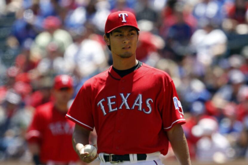 Texas Rangers starting pitcher Yu Darvish (11) reacts after giving up his second home run of...