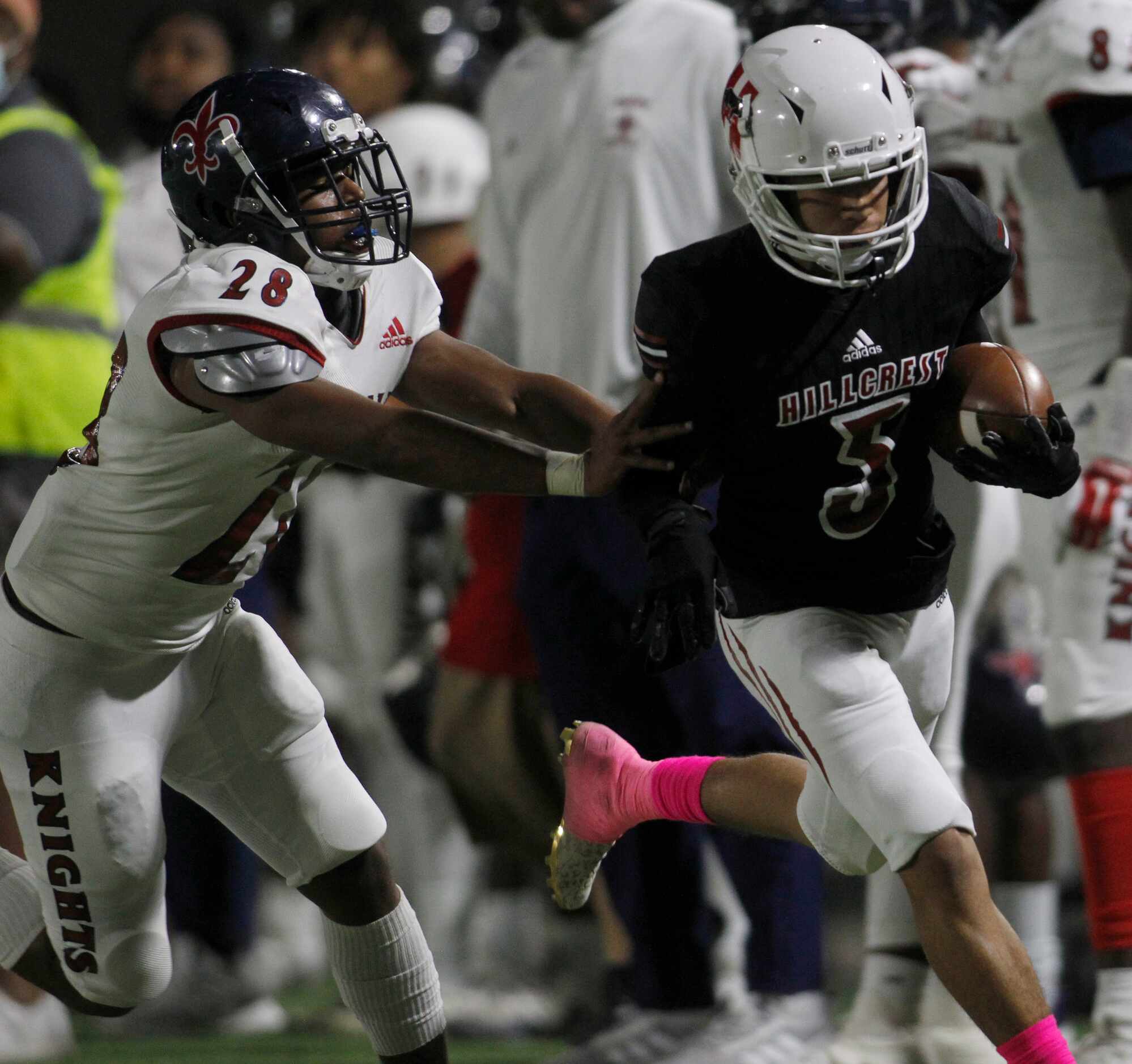 Dallas Hillcrest running back Shannon Cruse (5), right, is shoved out of bounds by Dallas...