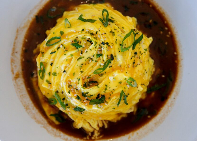 Okaeri Cafe's popular omurice is a mound of fried rice cloaked in a soft, swirled omelet...