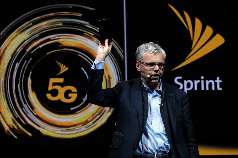 Michel Combes, CEO of Sprint, held the new LG V50 ThinQ 5G smartphone during a presentation...