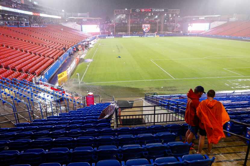 A portion of the field floods during a lightning delay before an MLS game between FC Dallas...