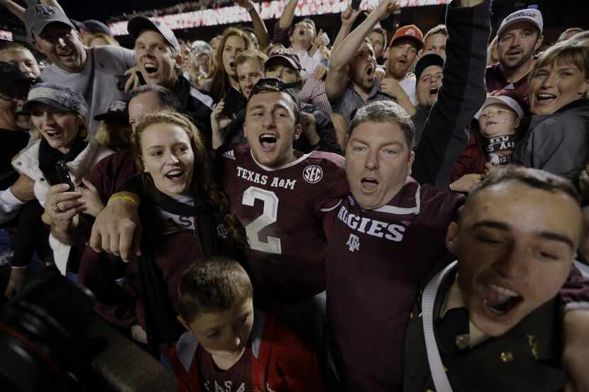 Texas A&M quarterback Johnny Manziel (2) celebrates with fans after an NCAA college football...