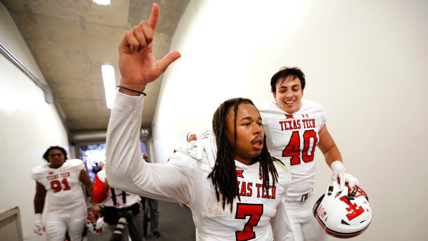 Texas Tech Red Raiders quarterback Jett Duffey (7) is congratulated on his win by linebacker...