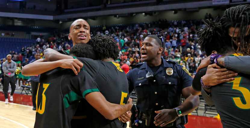 Madison players hug with tear of joy after defeating Brock in 3A  final. UIL boys basketball...