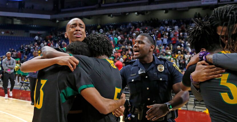 Madison players hug with tear of joy after defeating Brock in 3A  final. UIL boys basketball...