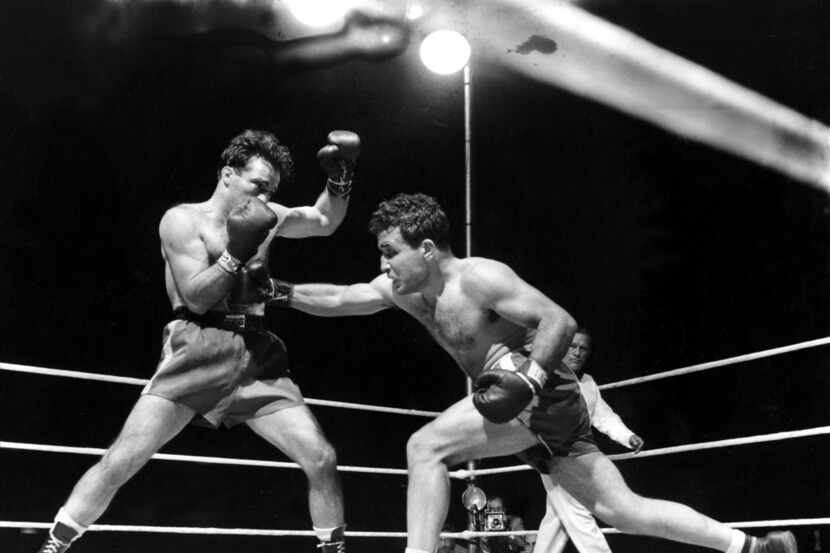FILE - This June 16, 1949, file photo, shows Jake LaMotta, right, fighting Marcel Cerdan in...