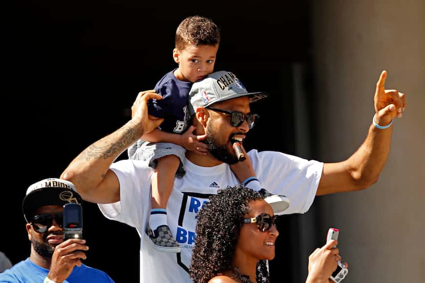 Tyson Chandler II sits atop his father's shoulders during the 2011 Dallas Mavericks NBA...