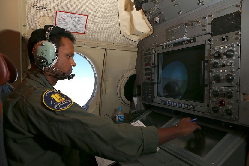Tactical Coordinator Imray Cooray works at his station on board a Royal Australian Air Force...