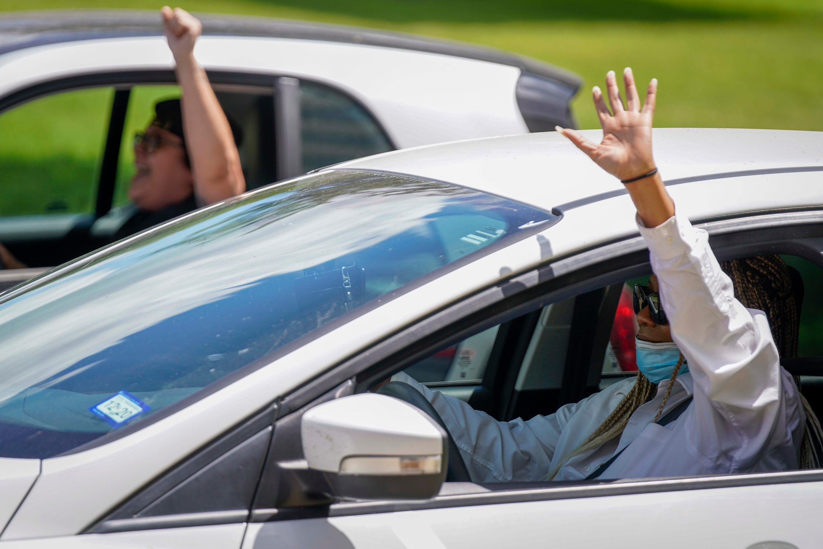 Motorist cheer in support of demonstrators as they march down Young Street following a rally...