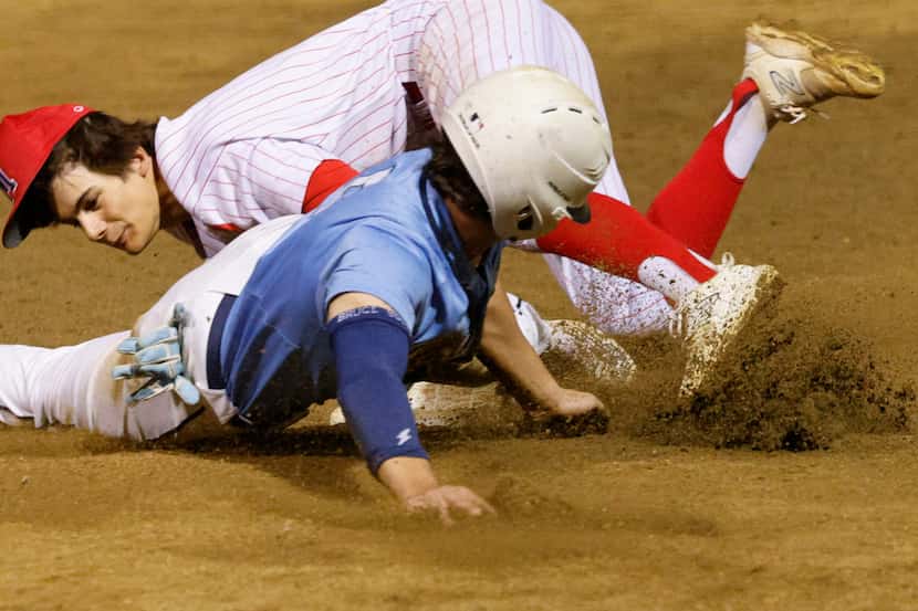 Flower Mound Adam Hawrylak, foreground, slides safely into third base before a tag by...