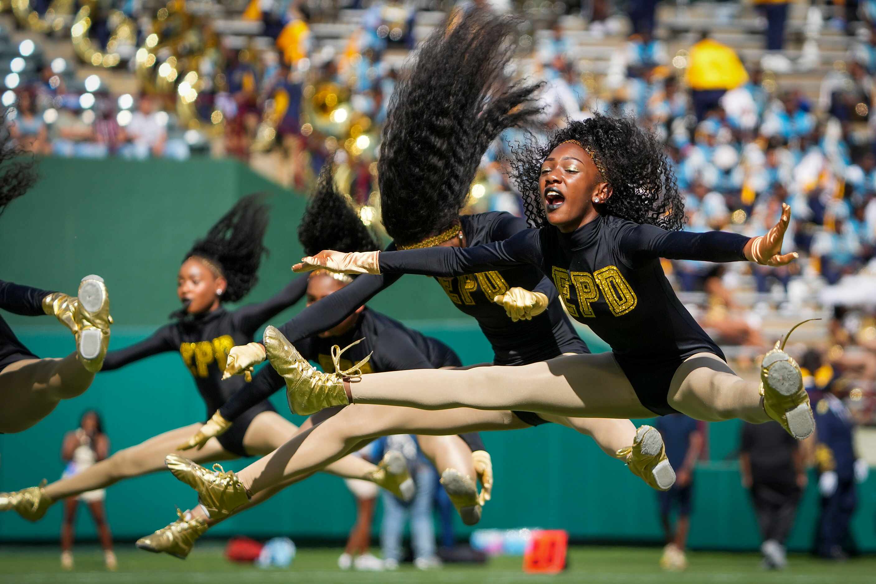 Members of the Elegant Princess Diamonds dance team perform before an NCAA football game...