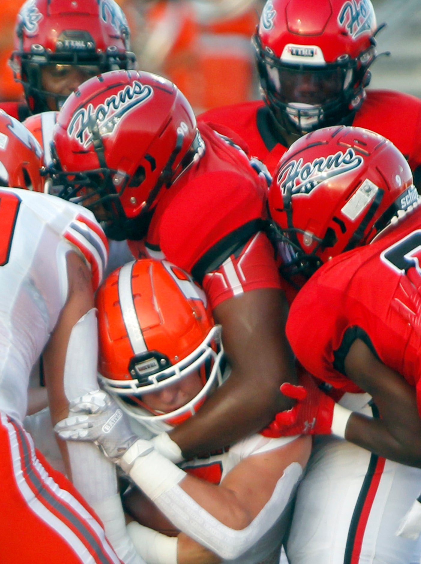 Rockwall quarterback lake Bennett (5) squeezes past a host of Cedar Hill defenders for a...