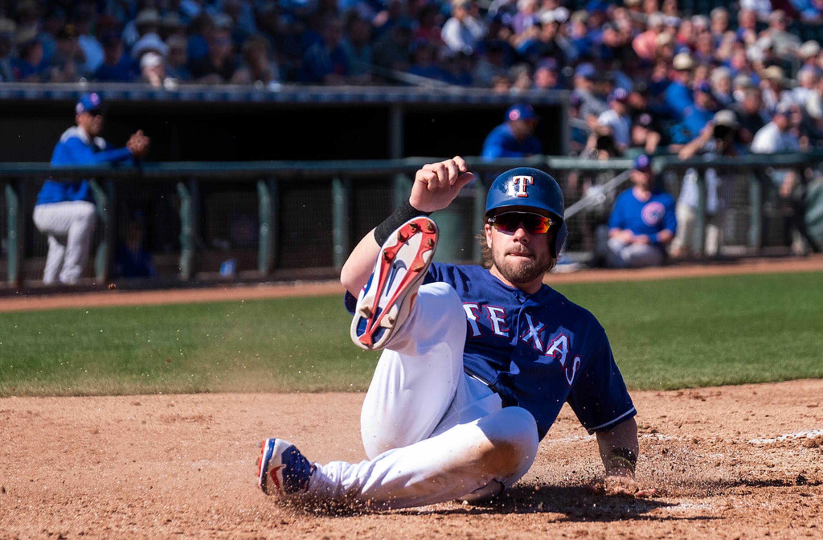 Texas Rangers infielder Patrick Wisdom scores on a double by outfielder Delino DeShields...