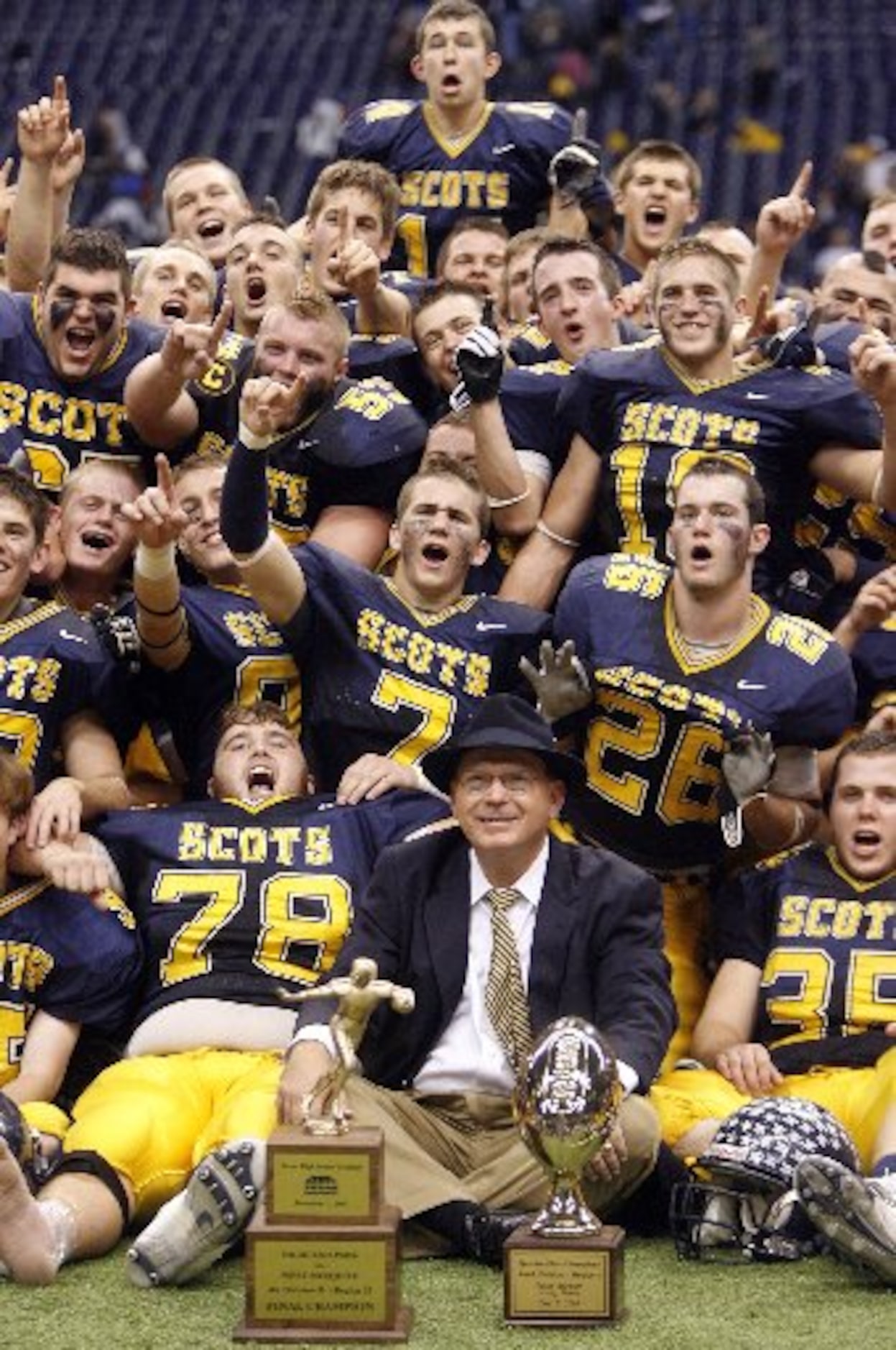  Highland Park coach Randy Allen (Cq) and his players celebrate their victory over West...