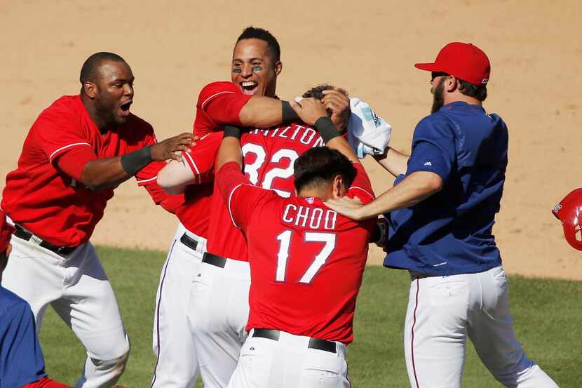 Texas Rangers' Josh Hamilton (32) is mobbed by teammates in celebration of his two-RBI...