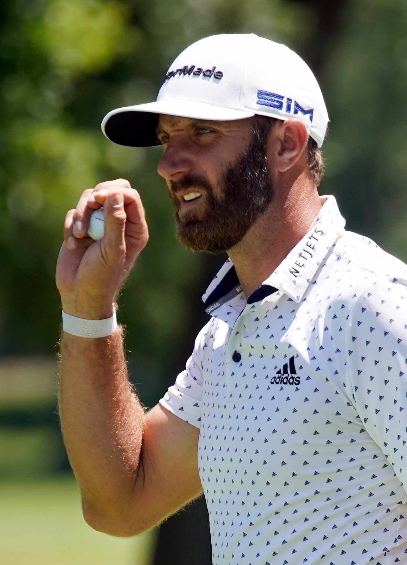 PGA Tour golfer Dustin Johnson waves after making birdie on No. 7 during the second round of...