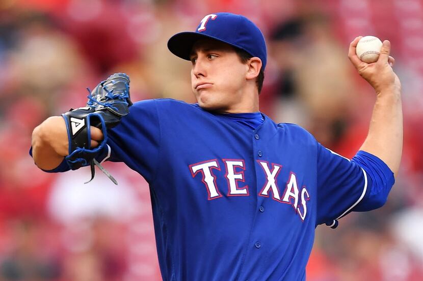 CINCINNATI, OH - AUGUST 23:  Derek Holland #45 of the Texas Rangers pitches in the second...