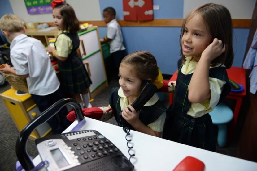 
Kindergarteners Lilly Cartwright (left) and Lucy Ann Mendoza play house.
