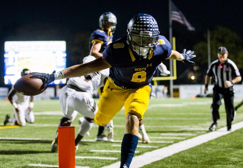 Highland Park running back Conner Allen (8) holds the ball over the goal line for a...