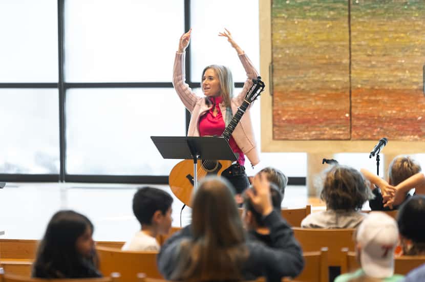 Cantor Vicky Glikin leads worship for students in grades 3-6