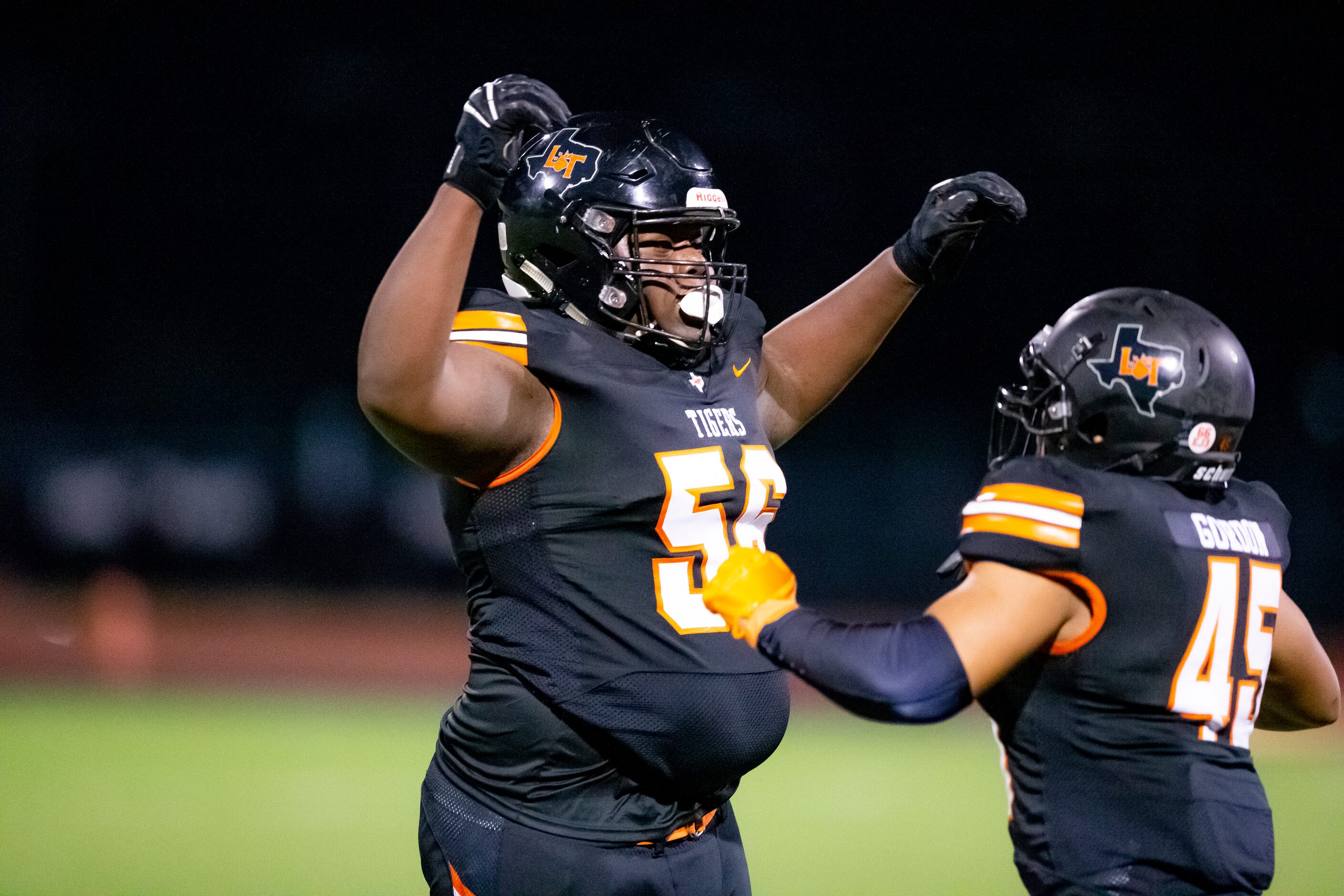 Lancaster junior defensive lineman Thomas Gort III (56) is congratulated by senior defensive...