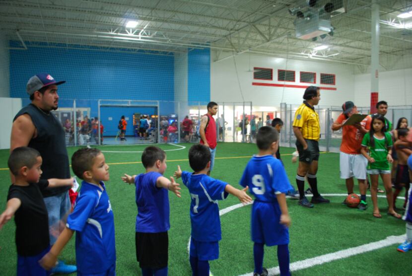 Team members of the Raiders indoor soccer team stand in line after their game on Tuesday...