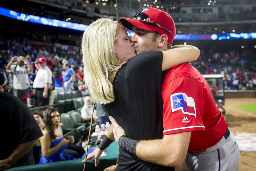 Texas Rangers outfielder Jared Hoying gets a kiss from his wife Tiffany Hoying after a 5-2...