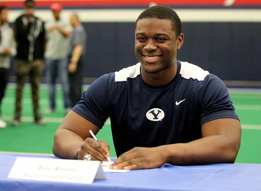 Allen's Tejan Koroma poses for a photo at the table during Allen's signing day ceremony on...
