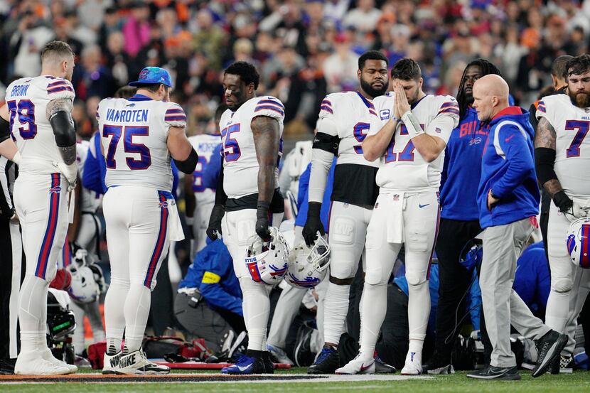 Buffalo Bills quarterback Josh Allen (17) pauses as Damar Hamlin is examined during the...