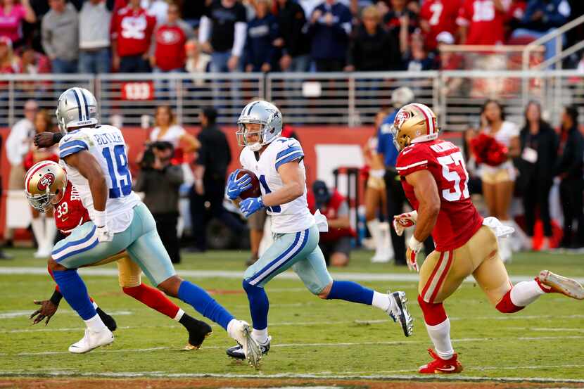 Dallas Cowboys wide receiver Cole Beasley (11) races across  the field as he is pursued by...