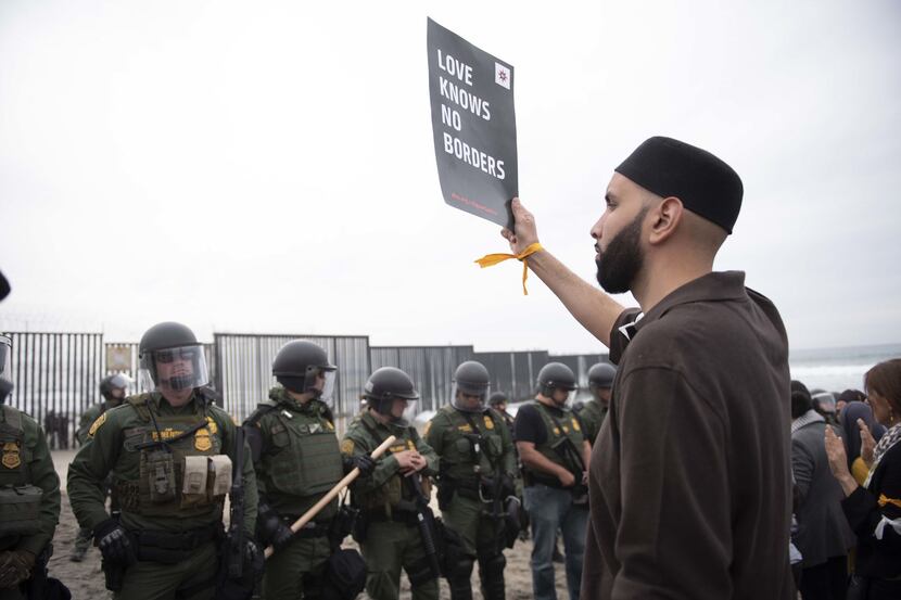 Imam Omar Suleiman protests U.S. immigration policies with a group of demonstrators at the...