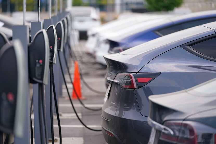 This file photo from 2020 shows unsold Tesla models charging outside a dealership in...