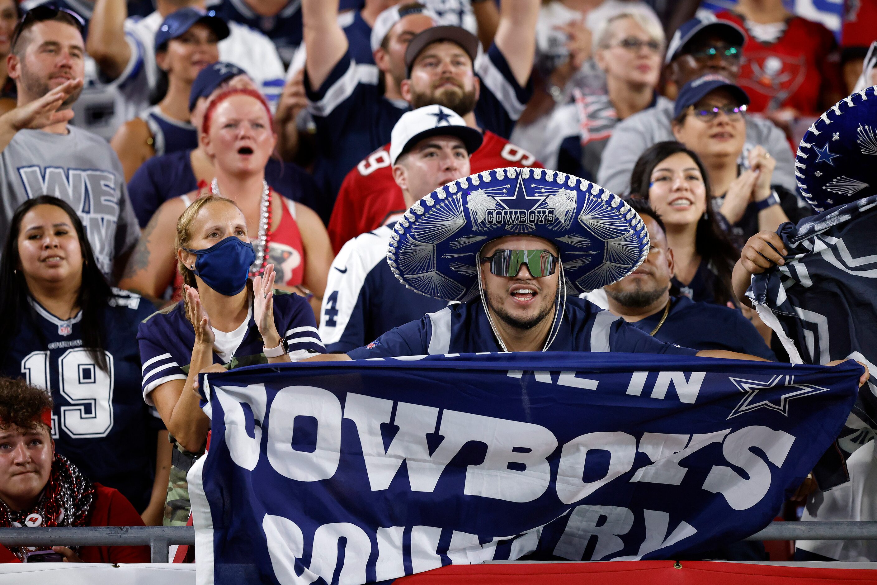 Dallas Cowboys fans celebrate a score in the first half against the Tampa Bay Buccaneers at...