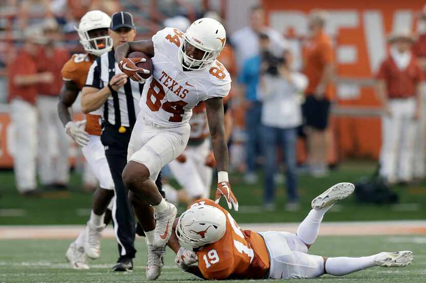Texas wide receiver Lil'Jordan Humphrey (84) leaps out of the grasp of Texas defensive back...