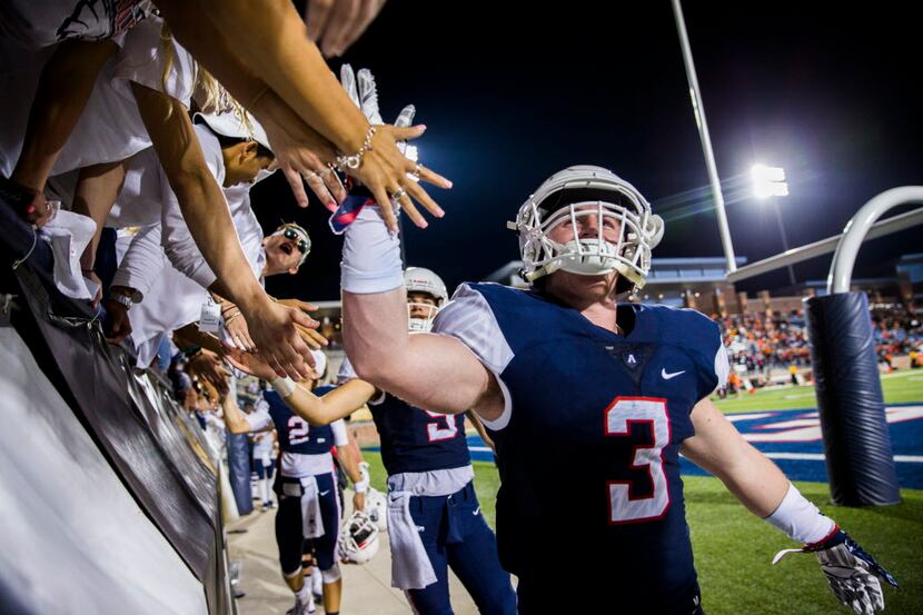 Allen defensive back Mason Wobbe (3) high-fives fans in the student section after a 25-7 win...