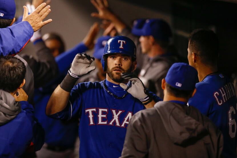 Mitch Moreland #18 of the Texas Rangers is congratulated after hitting a tie-breaking...
