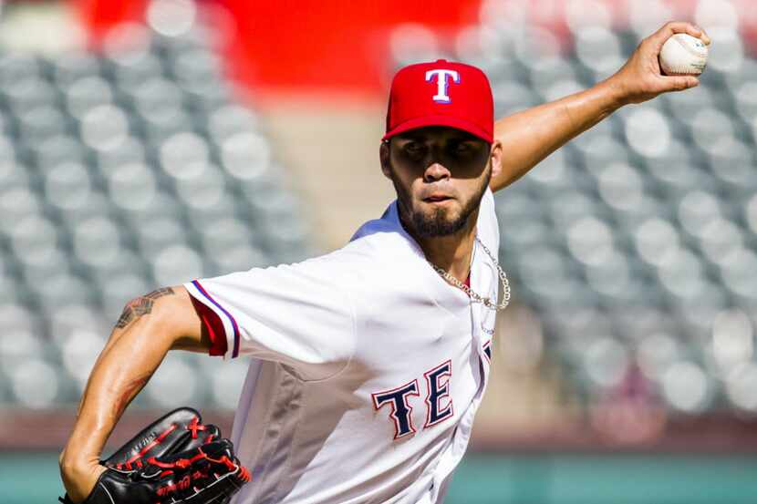 Texas Rangers relief pitcher Alex Claudio (58) pitches during the ninth inning of their game...