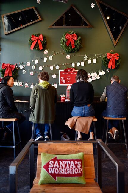 On one wall of Deck the Hall Street coffee shop, patrons can leave wishes for Santa.