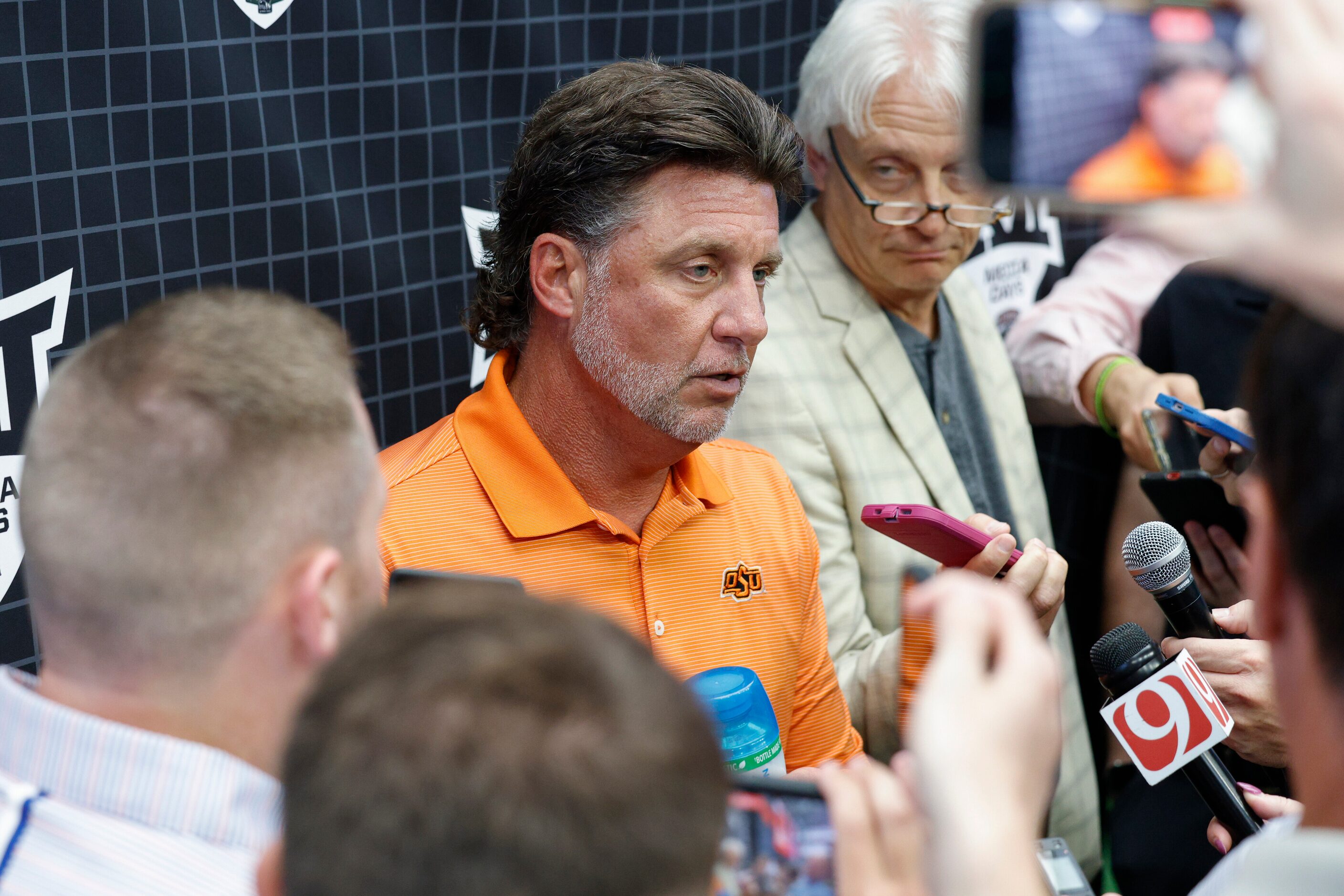 Oklahoma State head coach Mike Gundy speaks with reporters during the Big 12 Media Days at...