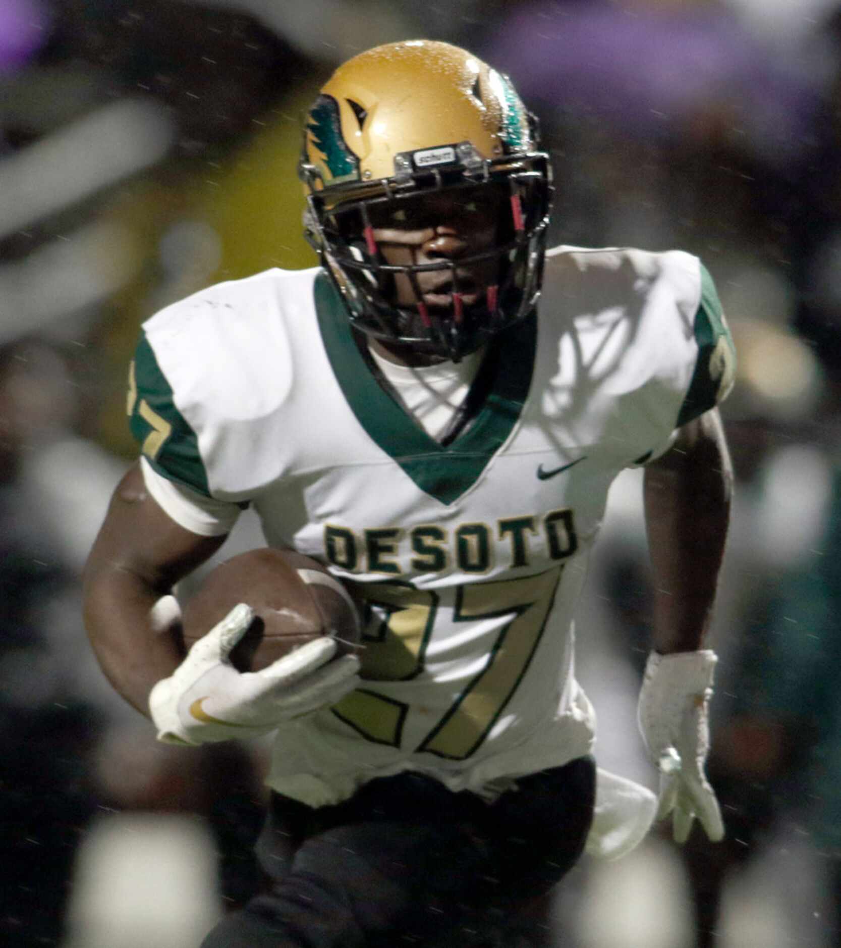 DeSoto running back Joshua Jackson (27) follows his blocks enroute to a 2nd quarter rushing...